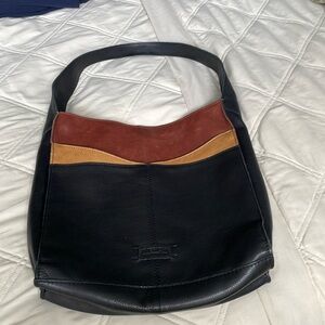 Lincoln Hobo.  Front pocket with magnetic closure.  11.5 W—. 12 H. — 3.5 D